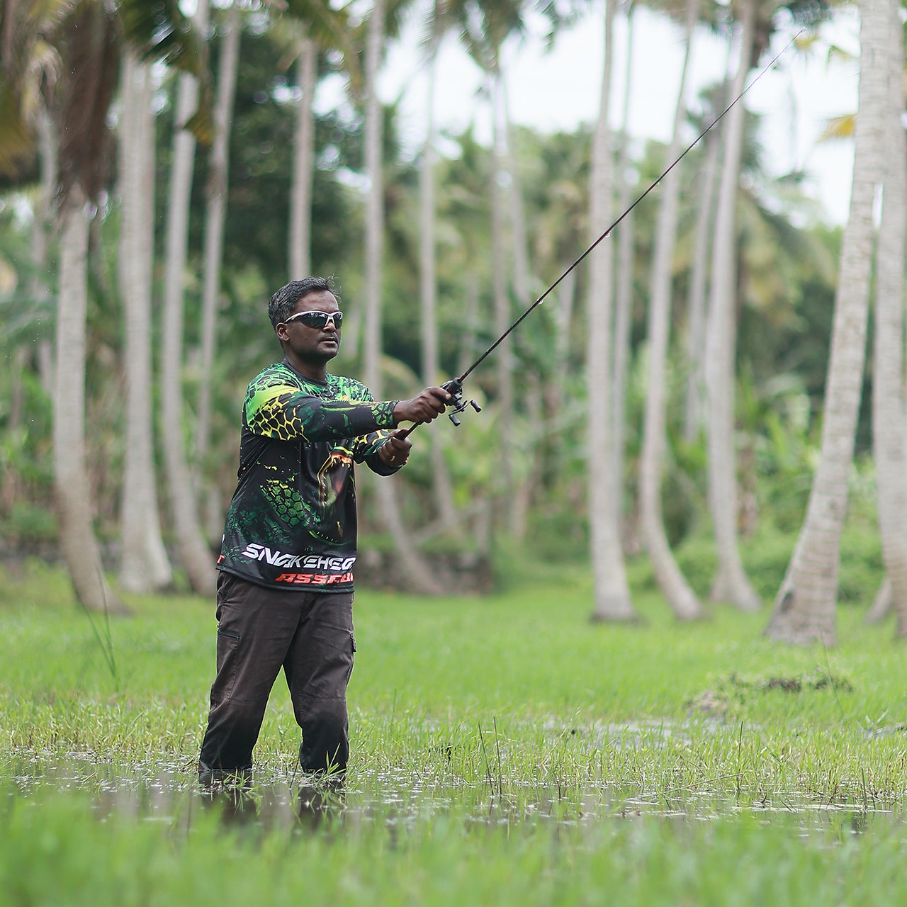 Eyida Snakehead Assault UPF_50_ Hooded Performance Fishing T-Shirt Hanish Standing In Swamp Casting Lure Fly