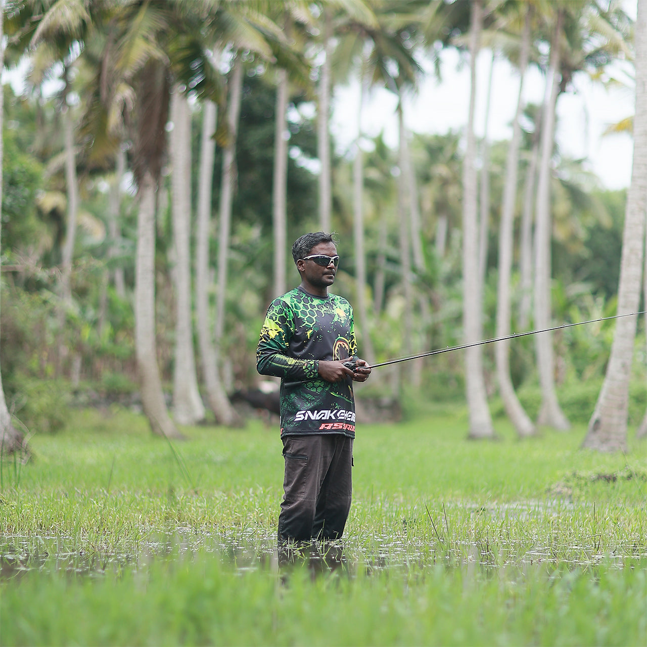 Eyida Snakehead Assault UPF_50_ Hooded Performance Fishing T-Shirt Hanish Standing In Swamp Ready to Cast